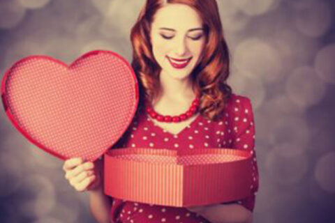 women holding a heart gift box