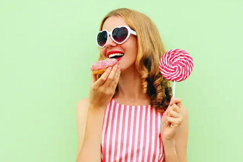 Sweet Young Woman Eating Donut